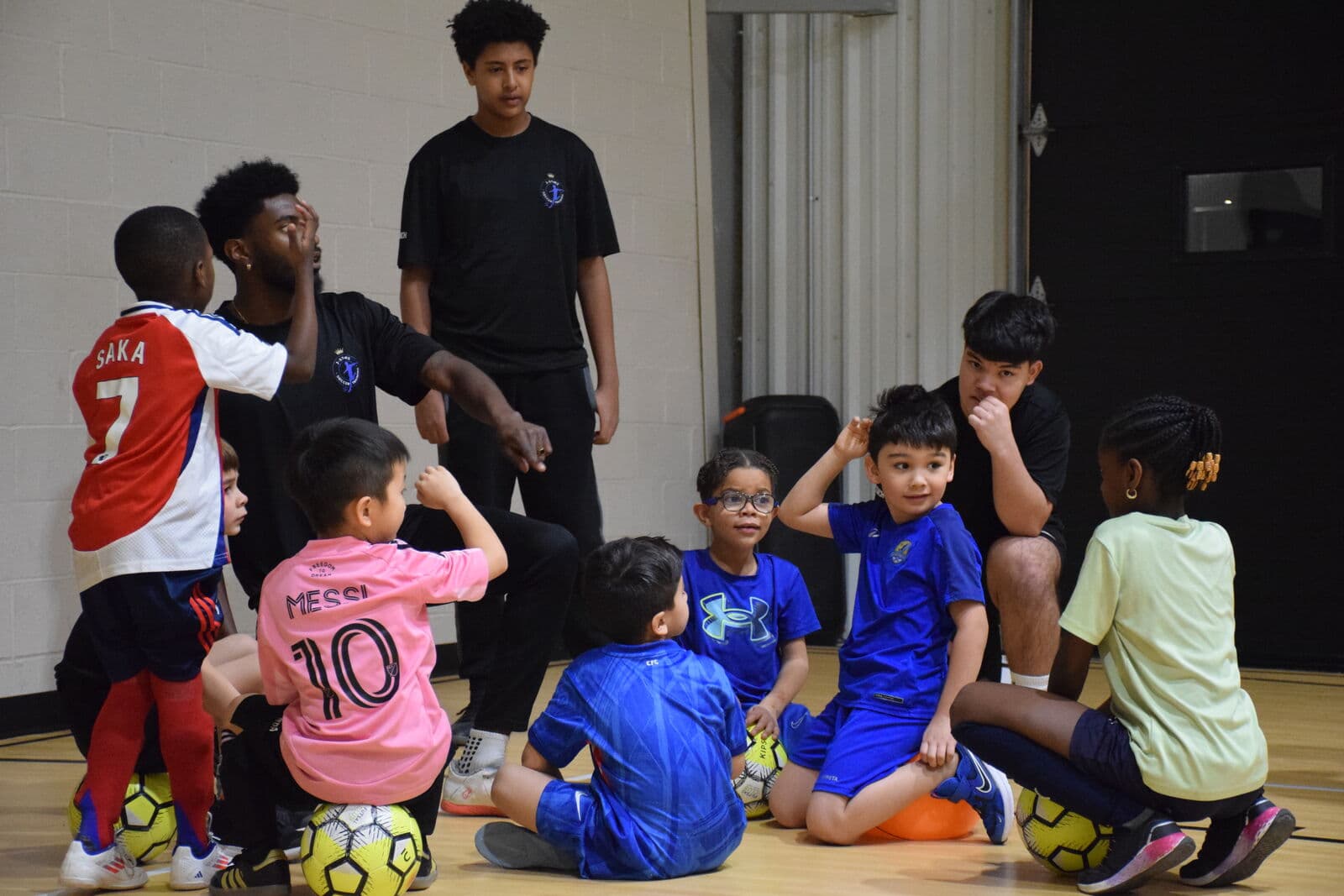 A young player dribbling at speed during JStarz training.