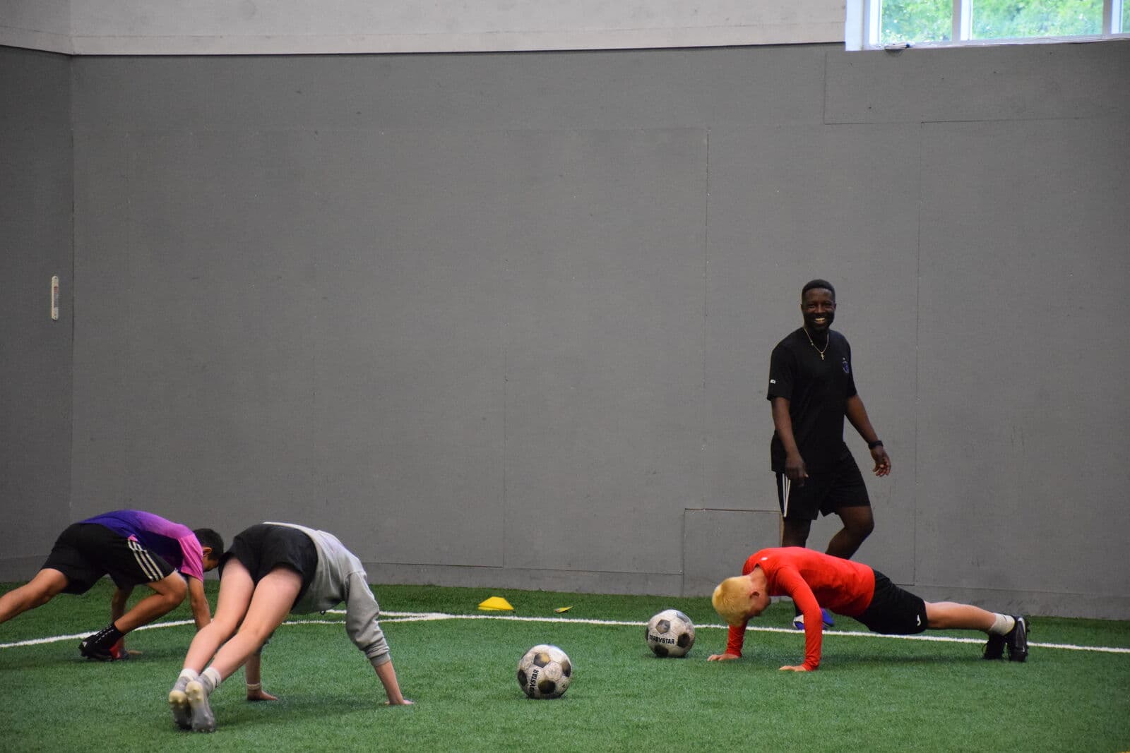 Senior performance coach Marvin Okello running a fitness session with young players.
