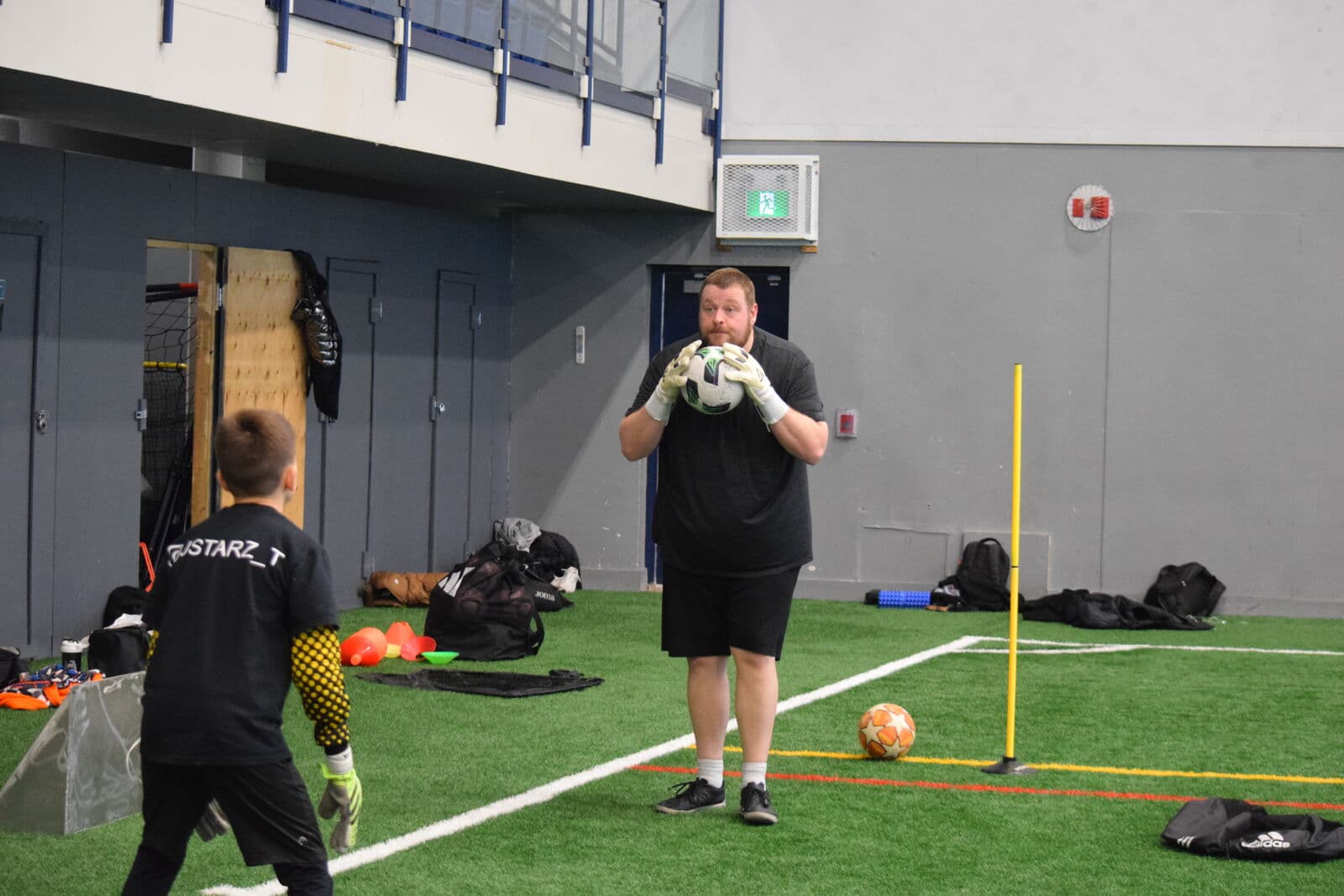 Head goalkeeper coach Zach Stevenson working a young keeper through a catching drill.